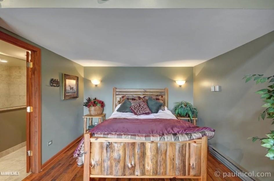 2287 West Hanover Road Hanover, IL 61041 - Photo 19 of 38 a bed sitting in a bedroom next to a window