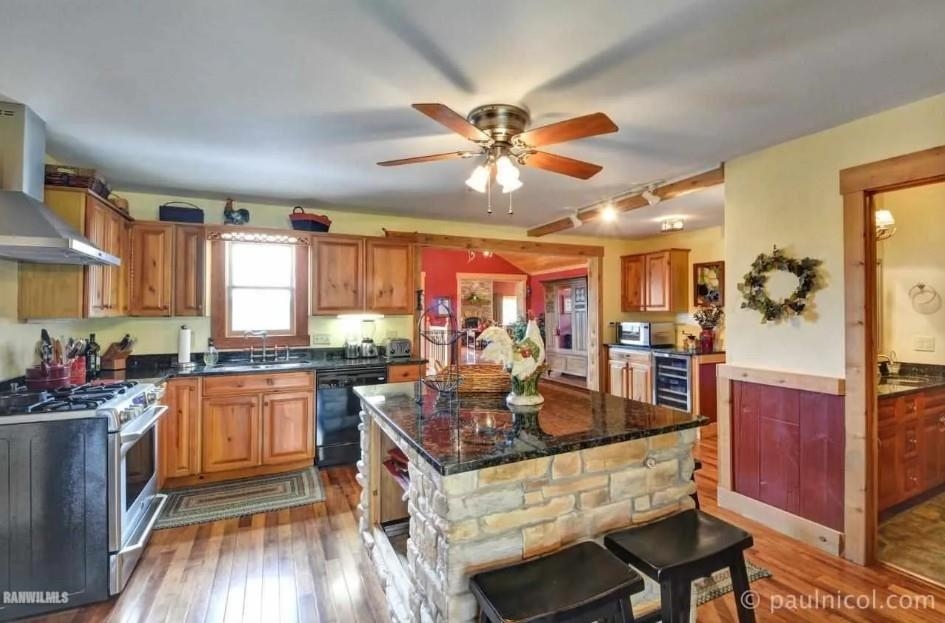 2287 West Hanover Road Hanover, IL 61041 - Photo 9 of 38 a kitchen with stainless steel appliances granite countertop a stove refrigerator and cabinets