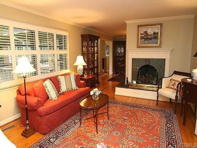 2605 Wells Avenue Raleigh, NC 27608 - Photo 4 of 12 Large formal living room has fireplace with gas logs, plantation shutters, and has great flow into the dining room and new family room. Living Room