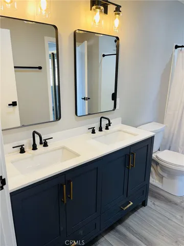a bathroom with double vanity sink and a mirror