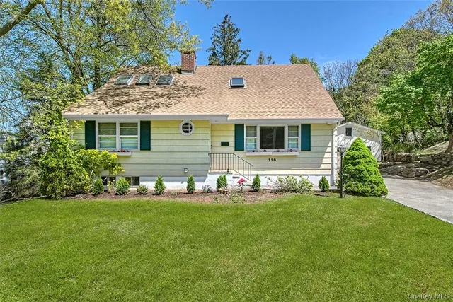 a view of a house with a yard and sitting area