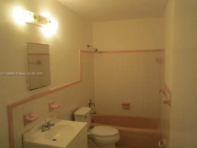 a bathroom with a sink mirror and toilet
