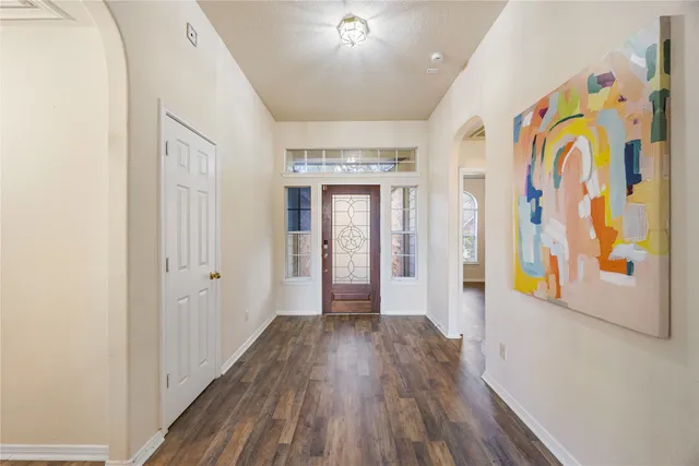 a view of hallway with wooden floor and door