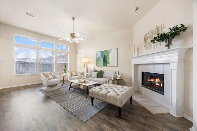 a living room with furniture fireplace and window