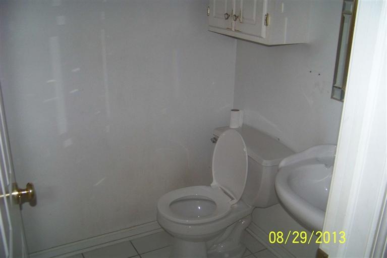 3528 Ridge Road Highland, IN 46322 - Photo 8 of 10 a white toilet sitting next to a shower