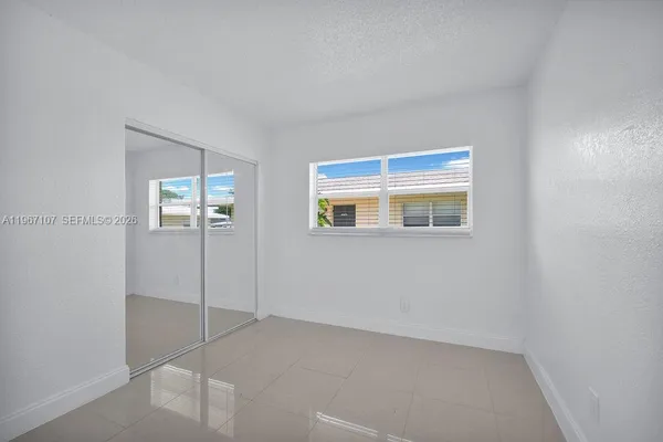 a view of an empty room with closet area