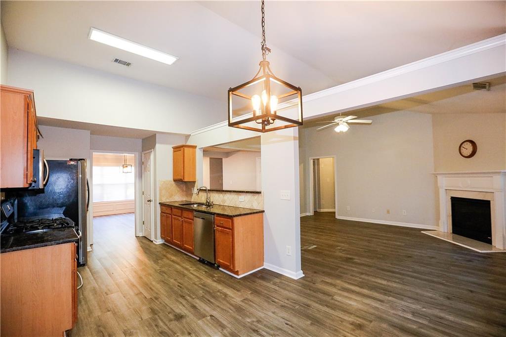 3264 Star Pine Court Duluth, GA 30096 - Photo 12 of 43 a kitchen with stainless steel appliances granite countertop a stove top oven a sink and a refrigerator