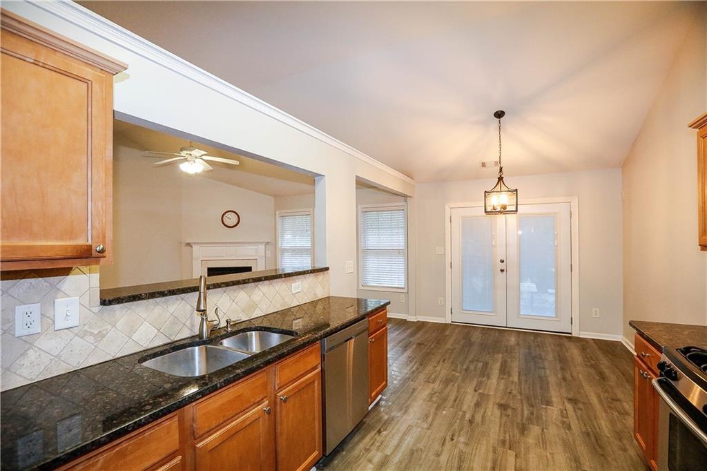 3264 Star Pine Court Duluth, GA 30096 - Photo 17 of 43 a kitchen with stainless steel appliances granite countertop a sink and wooden cabinets