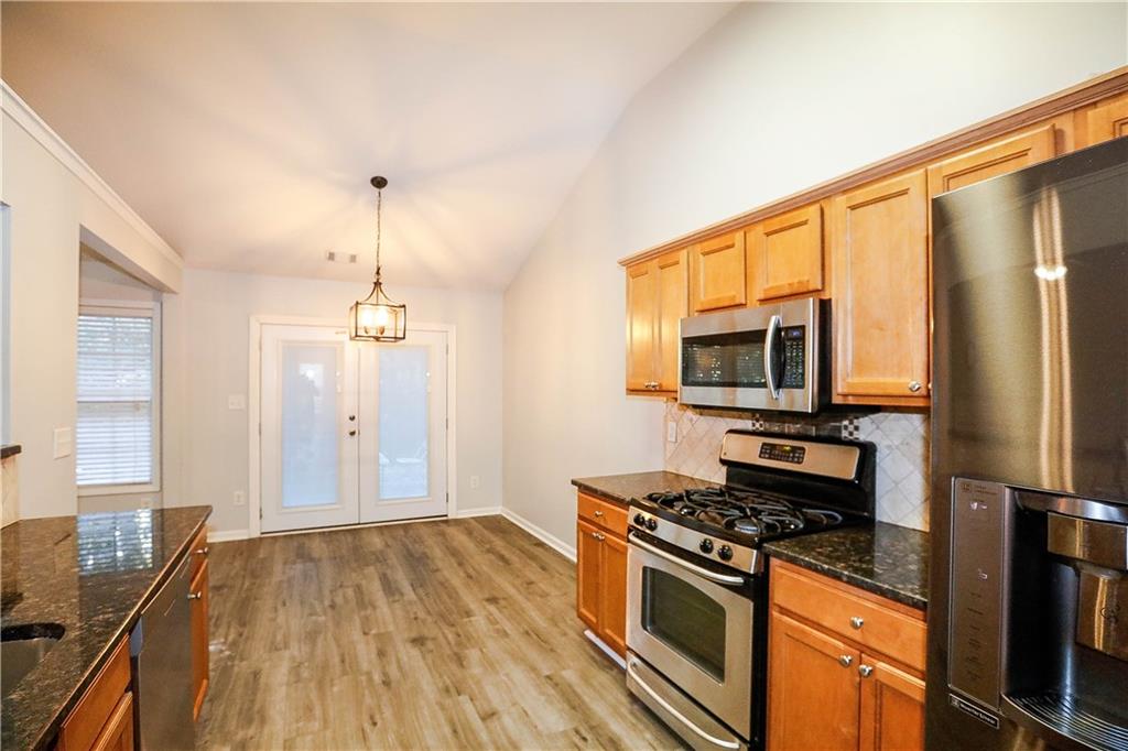 3264 Star Pine Court Duluth, GA 30096 - Photo 18 of 43 a kitchen with stainless steel appliances a stove refrigerator and microwave