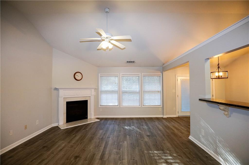 3264 Star Pine Court Duluth, GA 30096 - Photo 2 of 43 an empty room with windows cabinet and fireplace