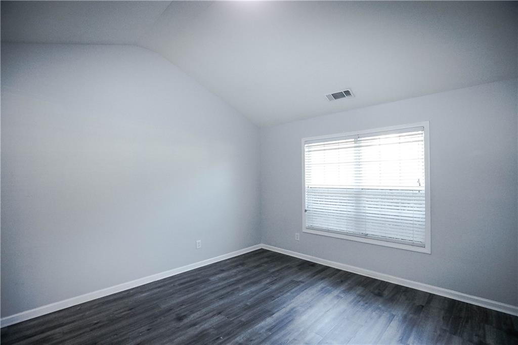 3264 Star Pine Court Duluth, GA 30096 - Photo 23 of 43 a view of an empty room with wooden floor and a window