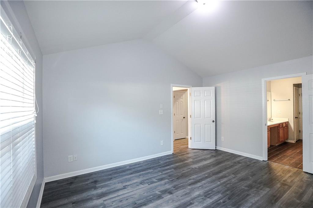 3264 Star Pine Court Duluth, GA 30096 - Photo 25 of 43 an empty room with wooden floor and windows