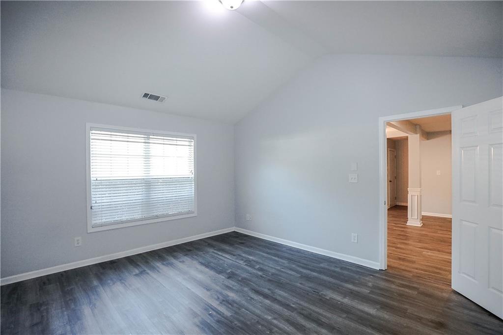 3264 Star Pine Court Duluth, GA 30096 - Photo 26 of 43 an empty room with wooden floor and windows