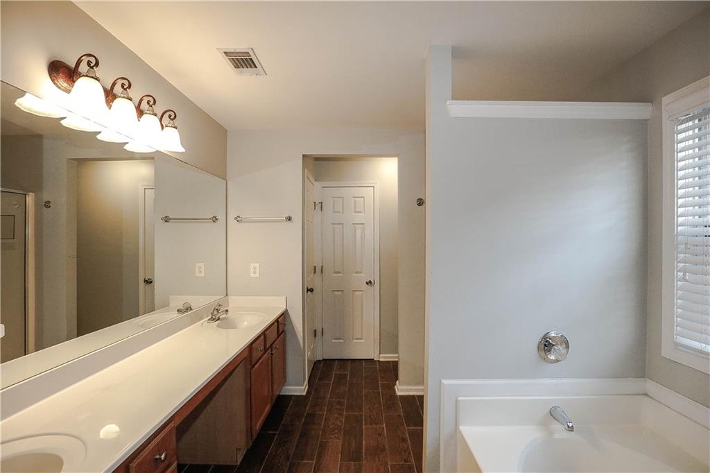 3264 Star Pine Court Duluth, GA 30096 - Photo 27 of 43 a bathroom with a double vanity sink and mirror with shower