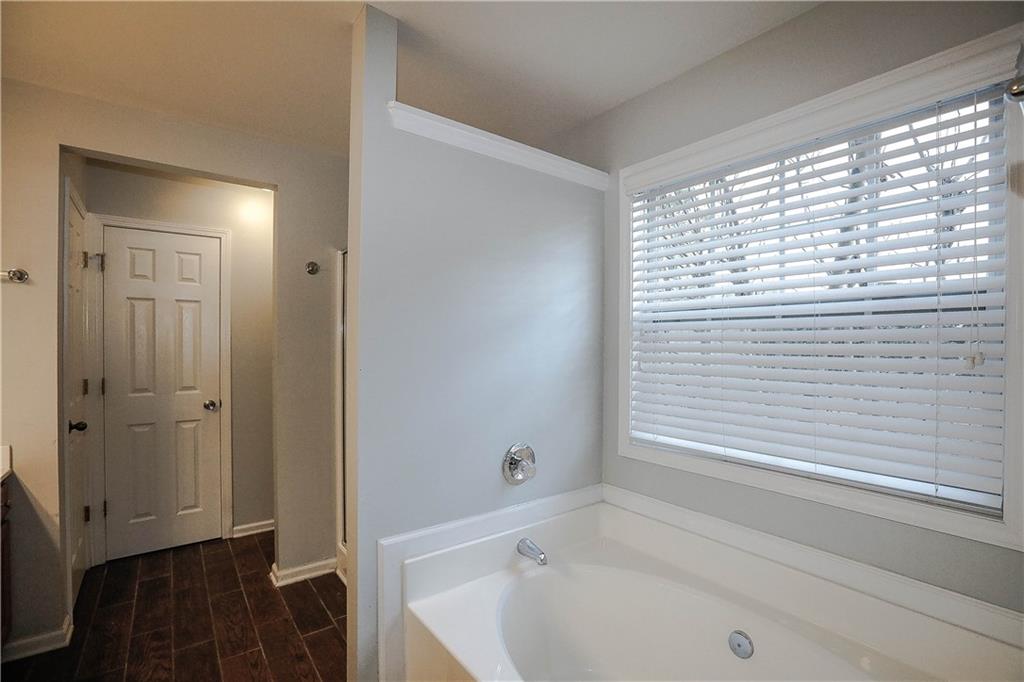3264 Star Pine Court Duluth, GA 30096 - Photo 29 of 43 a bathroom with a bathtub and a shower