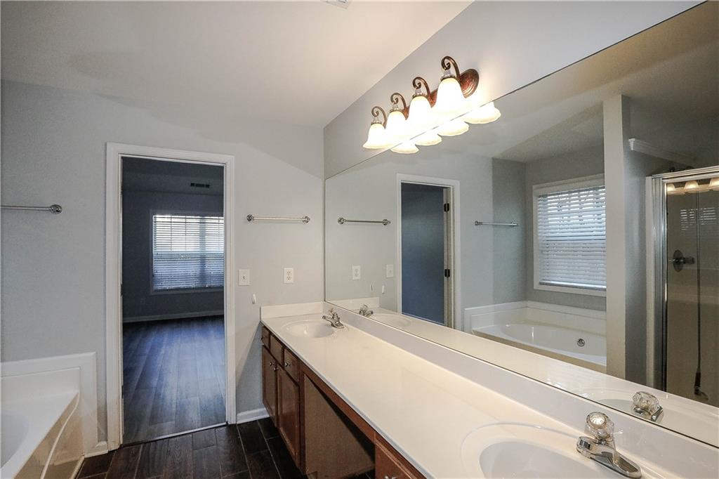 3264 Star Pine Court Duluth, GA 30096 - Photo 30 of 43 a en suite bathroom with a double vanity sink a mirror and a shower
