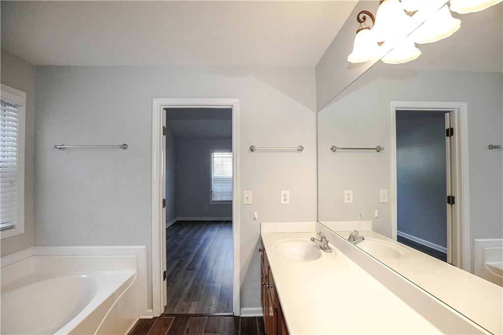 3264 Star Pine Court Duluth, GA 30096 - Photo 31 of 43 a bathroom with a tub sink and a mirror