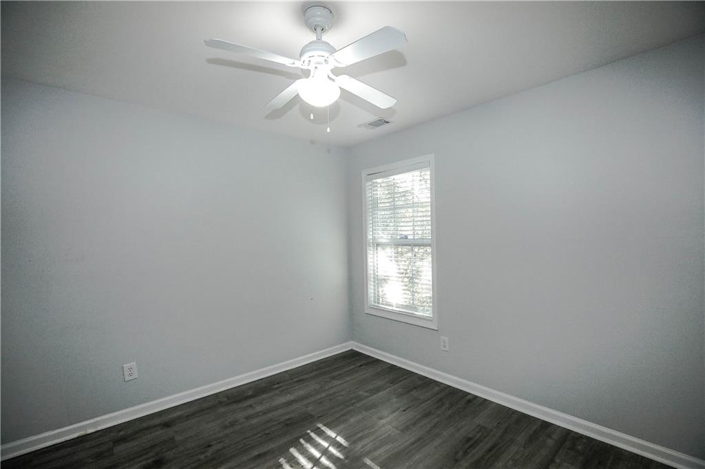 3264 Star Pine Court Duluth, GA 30096 - Photo 34 of 43 an empty room with wooden floor and windows