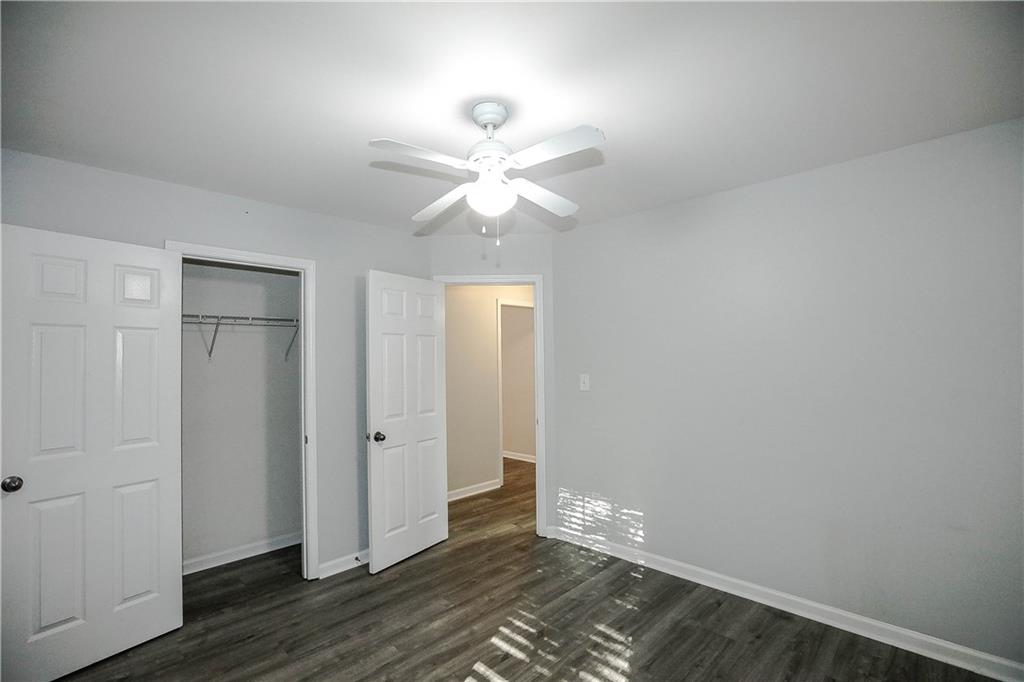 3264 Star Pine Court Duluth, GA 30096 - Photo 36 of 43 an empty room with wooden floor and a ceiling fan