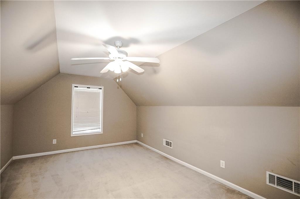 3264 Star Pine Court Duluth, GA 30096 - Photo 40 of 43 en empty room with windows and chandelier fan