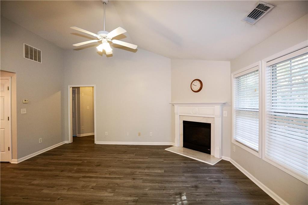 3264 Star Pine Court Duluth, GA 30096 - Photo 4 of 43 a view of an empty room with wooden floor and a window