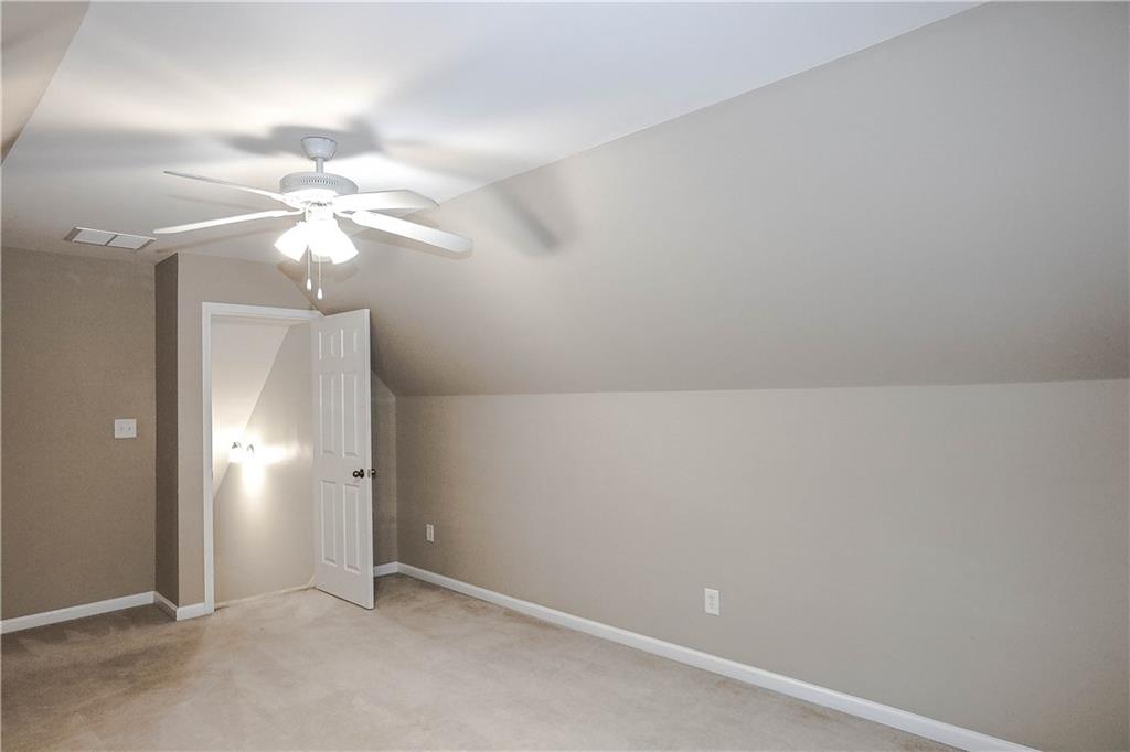 3264 Star Pine Court Duluth, GA 30096 - Photo 42 of 43 an empty room with a chandelier fan and a chandelier