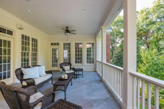 a living room with furniture a fireplace and a large window