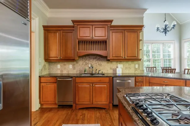 a spacious bathroom with a granite countertop sink a toilet and a mirror