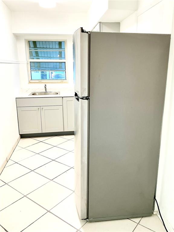 1645 Northeast 12th Street, Unit B Fort Lauderdale, FL 33304 - Photo 12 of 20 a bathroom with a sink and a mirror