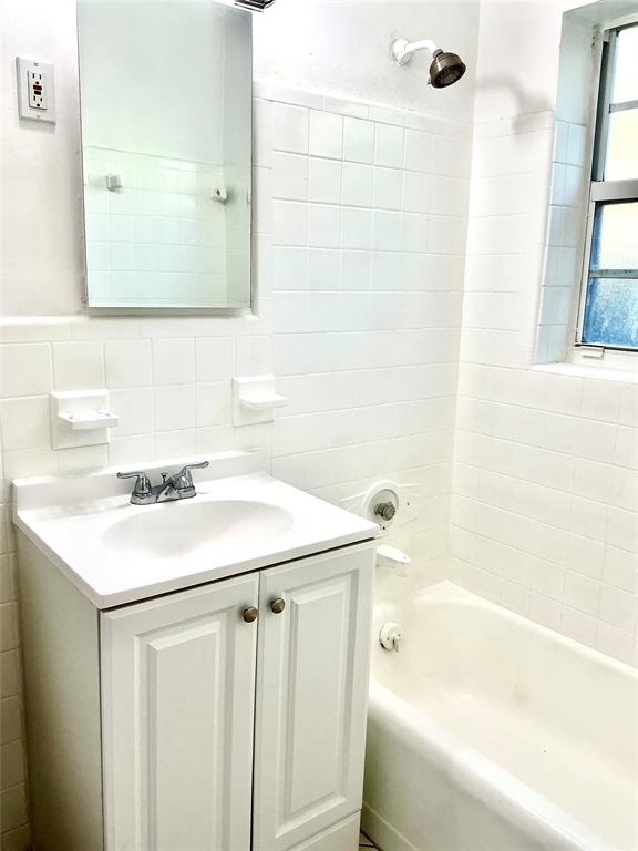 1645 Northeast 12th Street, Unit B Fort Lauderdale, FL 33304 - Photo 16 of 20 a bathroom with a sink and a bathtub