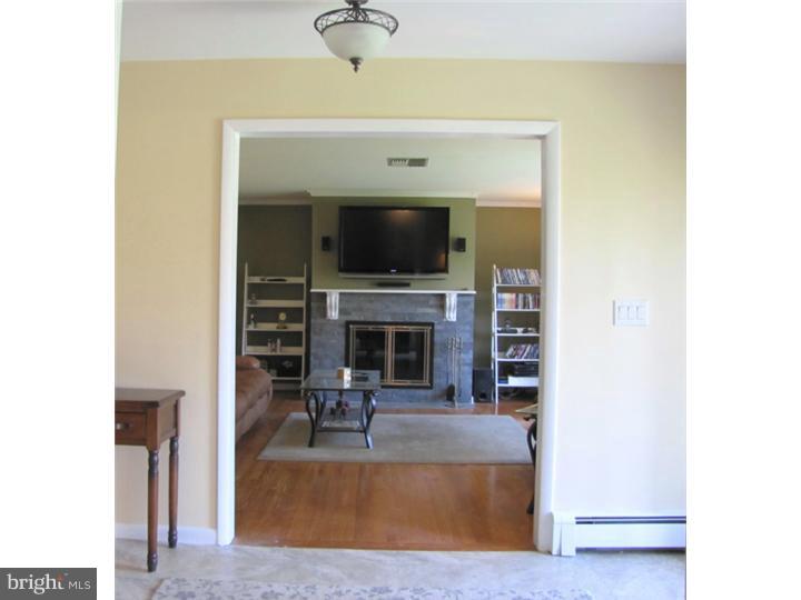 62 Pin Oak Road Skillman, NJ 08558 - Photo 2 of 21 a living room with fireplace furniture and a flat screen tv