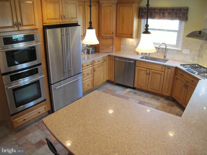 62 Pin Oak Road Skillman, NJ 08558 - Photo 7 of 21 a kitchen with granite countertop a sink stainless steel appliances and cabinets
