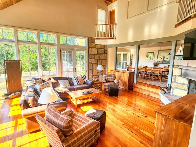 a room with pool table and a large window