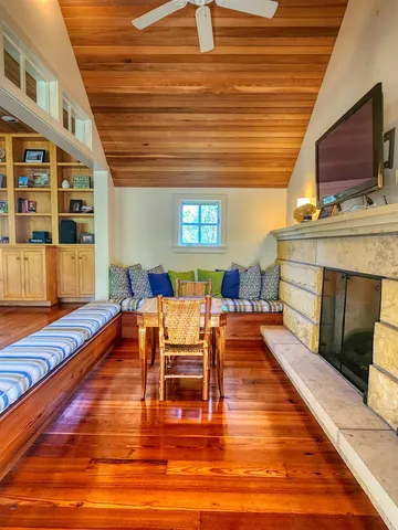 a living room with furniture and a floor to ceiling window