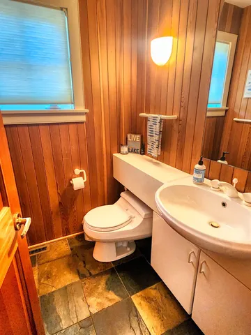 a view of a living room with furniture and floor to ceiling windows