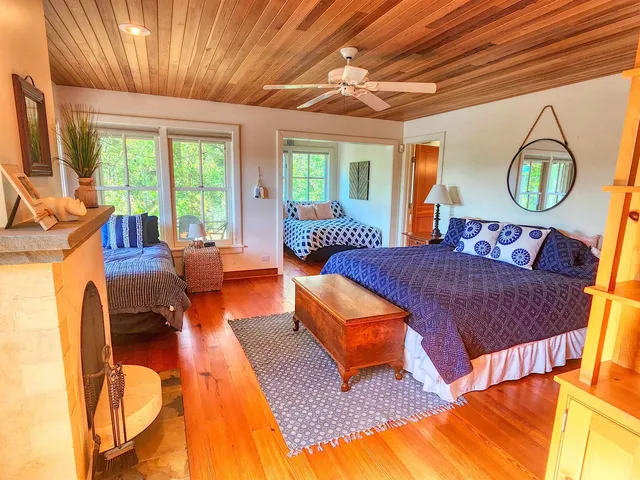 a bed sitting in a bedroom next to a window