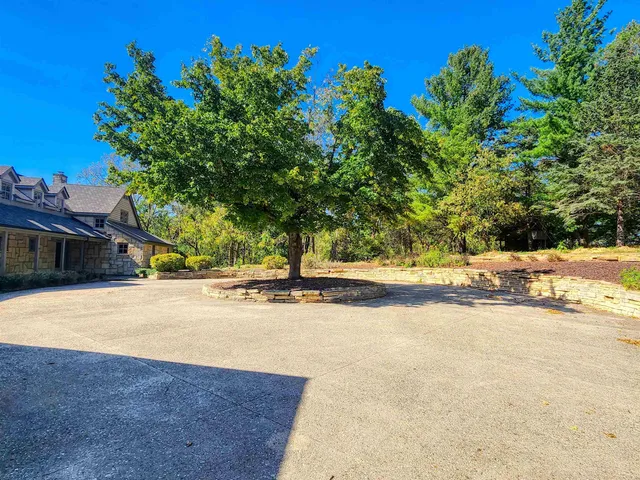 a living room with furniture a flat screen tv and a floor to ceiling window