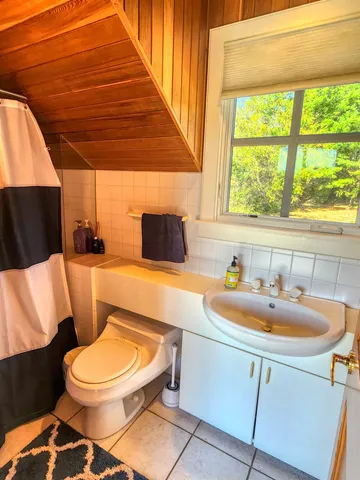 a view of a patio with table and chairs with wooden floor and fence
