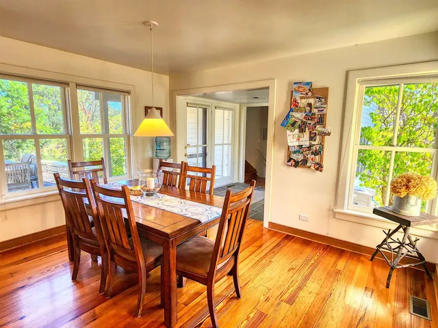 a kitchen with stainless steel appliances kitchen island granite countertop a table and chairs in it