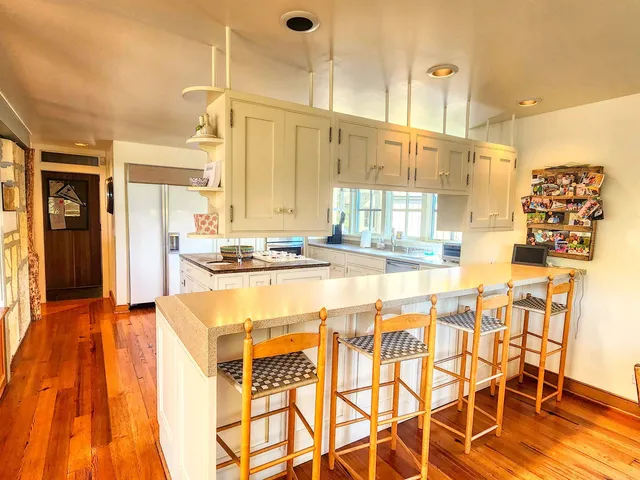 a view of a living room with furniture and wooden floor