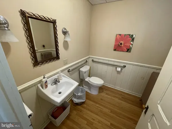 a bathroom with a toilet sink and mirror