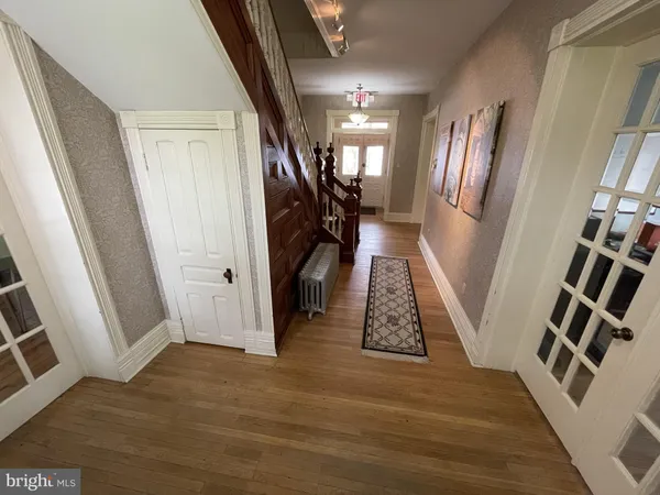a view of an entryway with wooden floor