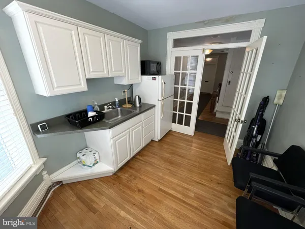 a kitchen with sink refrigerator and window