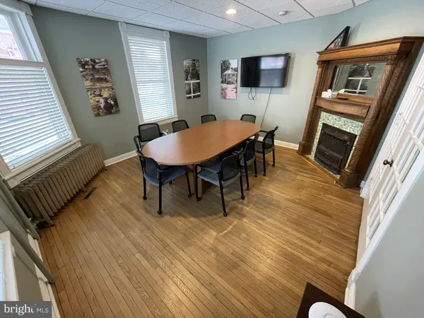 a view of a livingroom with furniture a flat screen tv and wooden floor