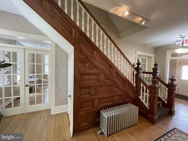 a view of entryway with wooden floor and stairs