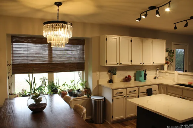 a kitchen with sink refrigerator and dining table