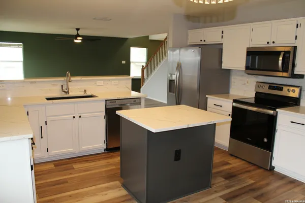 a kitchen that has a sink and a stove in it