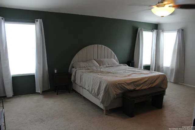 a spacious bedroom with a bed and a window