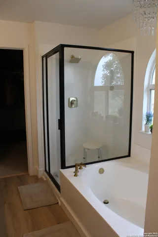 a bathroom with a bathtub and a shower