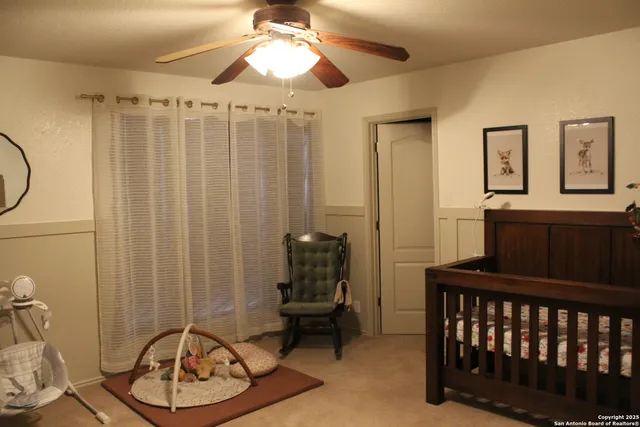 a bed sitting in a bedroom next to a window